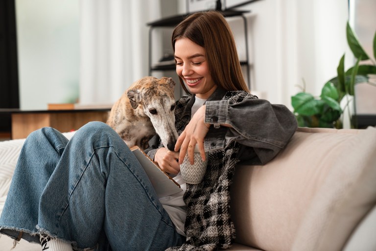 side-view-woman-sitting-with-dog-on-couch.jpg