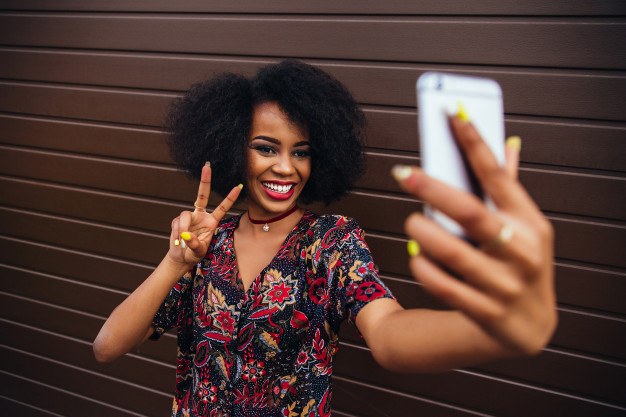young-afro-american-girl-showing-peace-sign-while-taking-selfie-mobile-phone_8353-6287.jpg